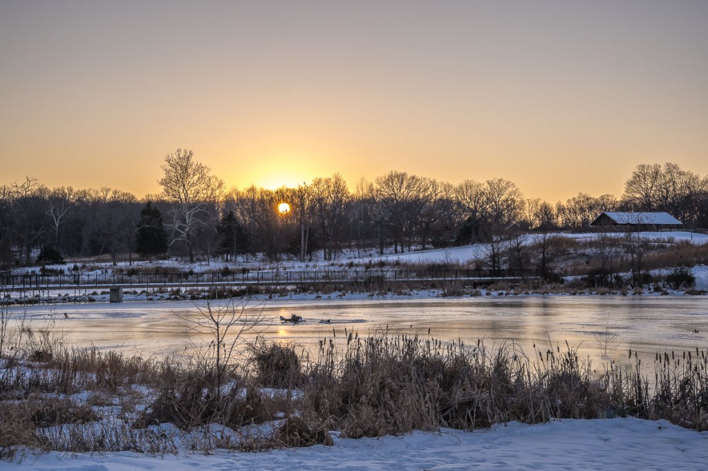 Frozen Beauty: Navigating the Icy Peril of a Snowy Lake at Sunset
